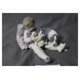 Lladro of sleeping boy with puppies