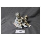 Lladro boy with an armful of puppies