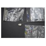 Three loose topaz(?) gemstones, black pearl, oblon