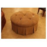 Round dressing ottoman in tan color with skirting