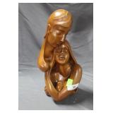 Wood carving of embracing couple