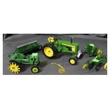 Two John Deere tractor models with three