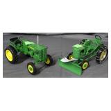 Two John Deere model tractors - one with snow