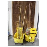 Two Rubbermaid mop buckets Wave break & Caution wi