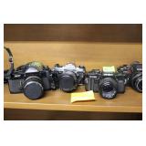 Four cameras: Canon EF, Pentax Super Program,