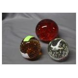 Three timed release paperweights
