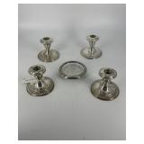 Four weighted sterling candlesticks & sterling