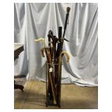 Brass umbrella stand with 7 canes, 1 walking stick