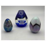 Three art glass egg paperweights