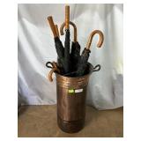 Copper umbrella stand with classy umbrellas