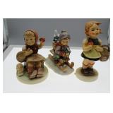 Three Goebel figures - girl with basket, sledding
