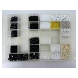 Two organizers of beads - black beads, white &