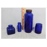 Four cobalt medicine bottles