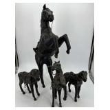 Four leather wrapped horse figures - one missing
