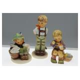 Three Goebel figures - boy with bunnies, boy with