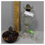 Two 1800s oil lamps & two minature chimneys. Flora