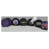 Seven mostly NHL Hockey Pucks some with signatures