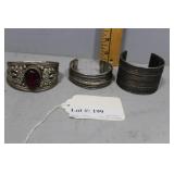 Three silver-plate cuffs incl dark red stone