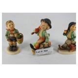 Three Hummel Figurines: boy with umbrella and Scot