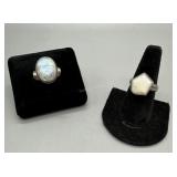 Two Sterling opaque and rainbow moonstone rings