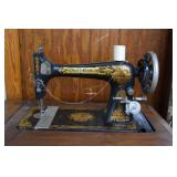 Oak sewing machine cabinet with ornate gold design