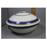 Blue & white painted covered urn with insignia top