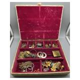 Jewelry box with pink velvet lining filled with co