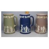 Three Wedgwood Jasperware pitchers in blue, green