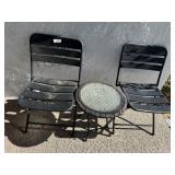 Two metal patio chairs and glasstop round patio ta