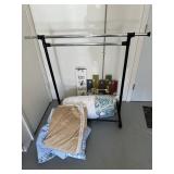 Clothing rack, bed linens, and two wooden signs