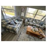 Plaid sofa and loveseat with eight pillows in blue