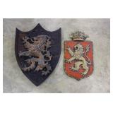 Metal lion crest on shield & Plaster lion crest