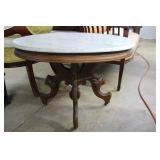 Oval marbletop coffee table with carved fruit waln