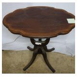 Pedestal oval side table with acorn adornment