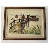 Framed embroidery of harbor scene with pelican fri
