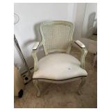 Cane back arm chair with button tuck seat