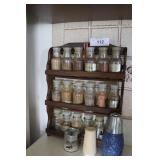 Spice rack with spice jars, thermometers, bottle o