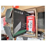 Assorted partial boxes of nails and staples