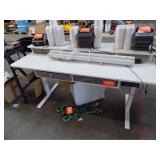 Electric standing desk w/ cubby storage seated pos