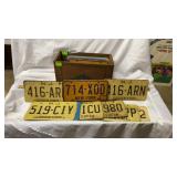 22 Assorted License Plates in a Wooden Crate