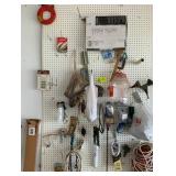 Contents on Peg Board, Drain Snake, C-Clamp, Brush