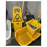 ROLLING MOP BUCKET AND WET FLOOR SIGN. LOT LOCATED