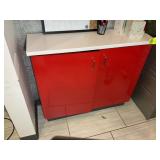 RED TWO DOOR CABINET WITH WHITE TOP, 40 IN X 12 IN