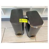 PAIR OF BLACK TRASH CANS WITH LIDS.