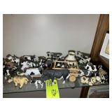 SHELF OF COW FIGURINES