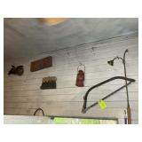 GROUP OF VINTAGE ITEMS ON WALL, HAND SAW, LANTERN,
