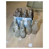 Sorted group of glass milk bottles