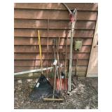 Group of yard tools, pitchfork, plastic rake, pole