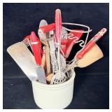 crock filled with antique kitchen utensils