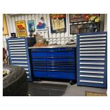 Large Matco rolling tool chest flanked by matching drawer cabinets with automotive signage above.